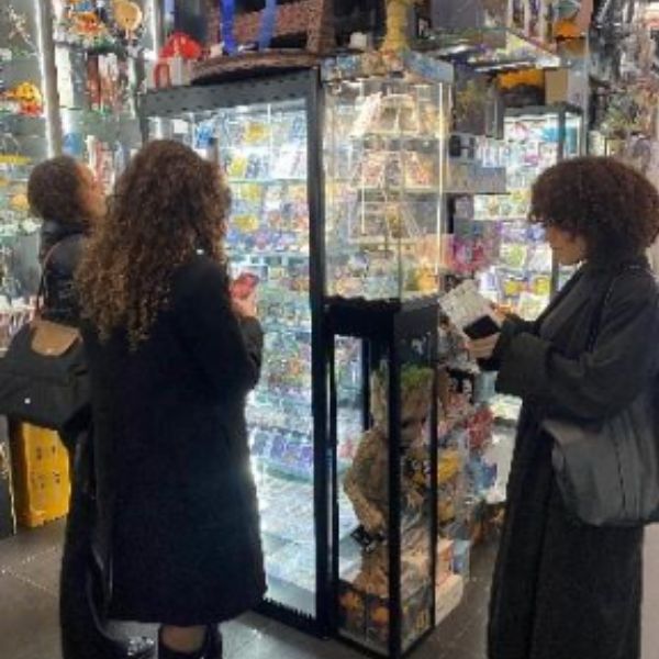 Trois étudiantes de dos regardant une vitrine manga