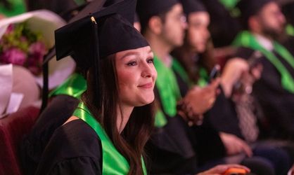 Jeune femme brune en tenue de diplômée